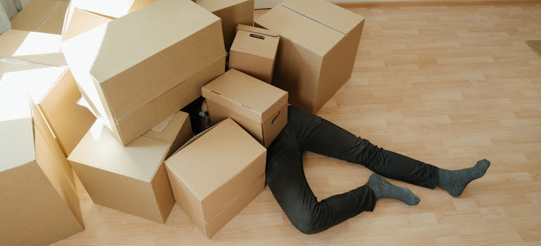 A person under a pile of boxes