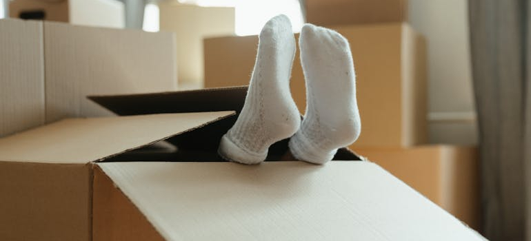 child lying in a box