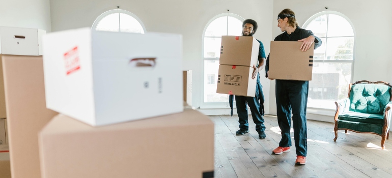 Two movers carrying boxes