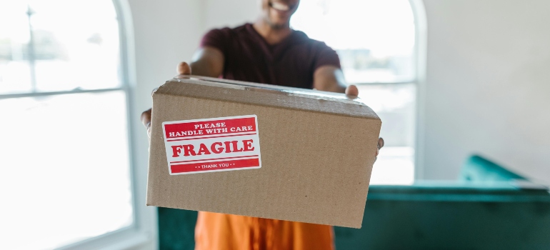 Man holding moving box, Oakland Country Movers