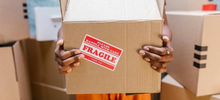 a woman holding a fragile box