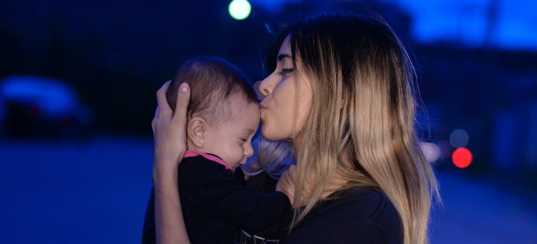 Woman kissing a baby 