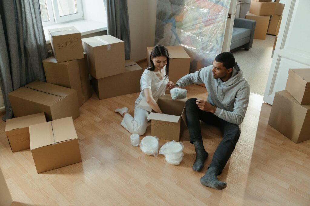 a couple packing for move and using services of moving companies dearborn mi