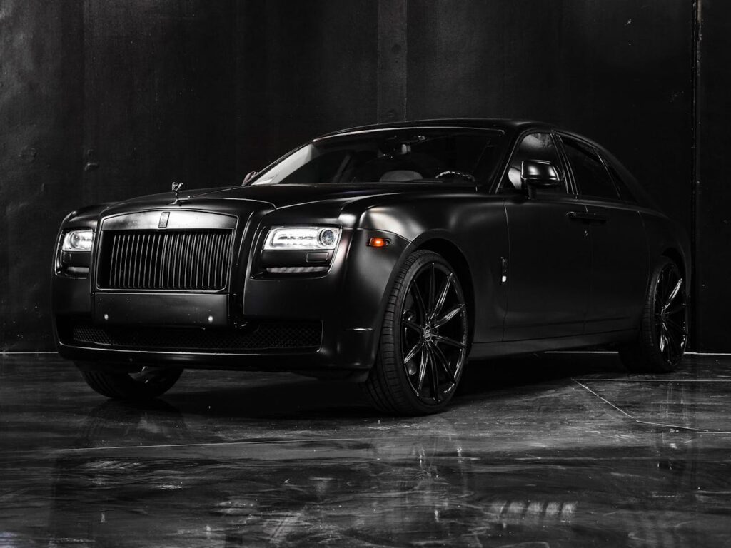 A black Rolls Royce awaits enclosed transport, the top choice for shipping a car.
