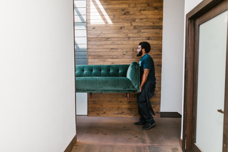 mover carrying a sofa