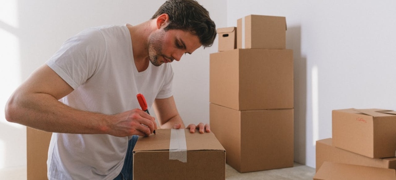a man carefully packing and following our moving supplies guide